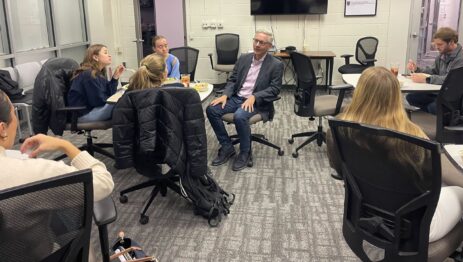 A group of students sitting in a room with a professional guest speaker.