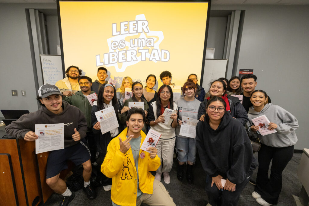 Ivan Mendoza is pictured with many members of a book club at a group meeting.