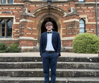 Picture of Chase Whalen in front of old brick building
