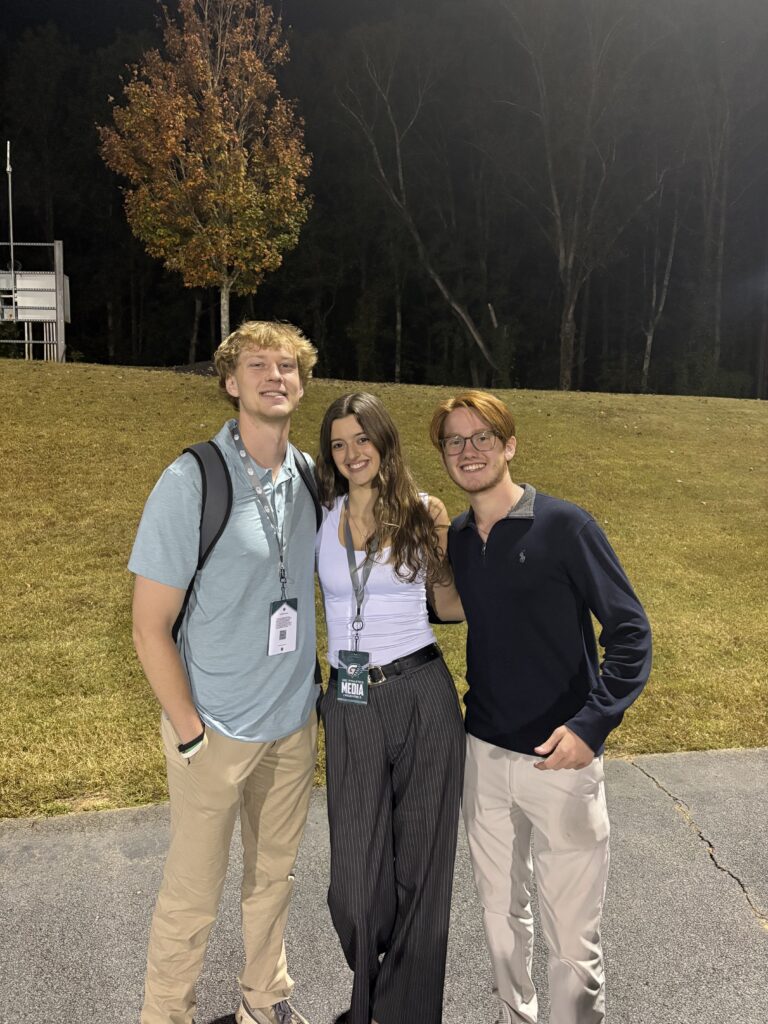Brooks Thomason smiles alongside two friends.