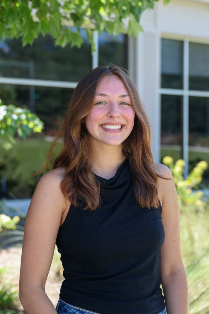 Lily Alarcon smiles for a headshot outside Grady College.