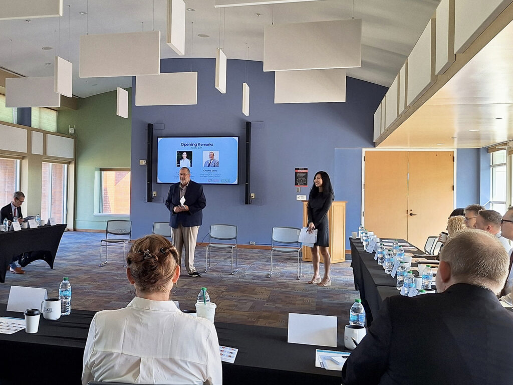 Dean Davis and Yan Jin stand and make a presentation in front of people sitting.