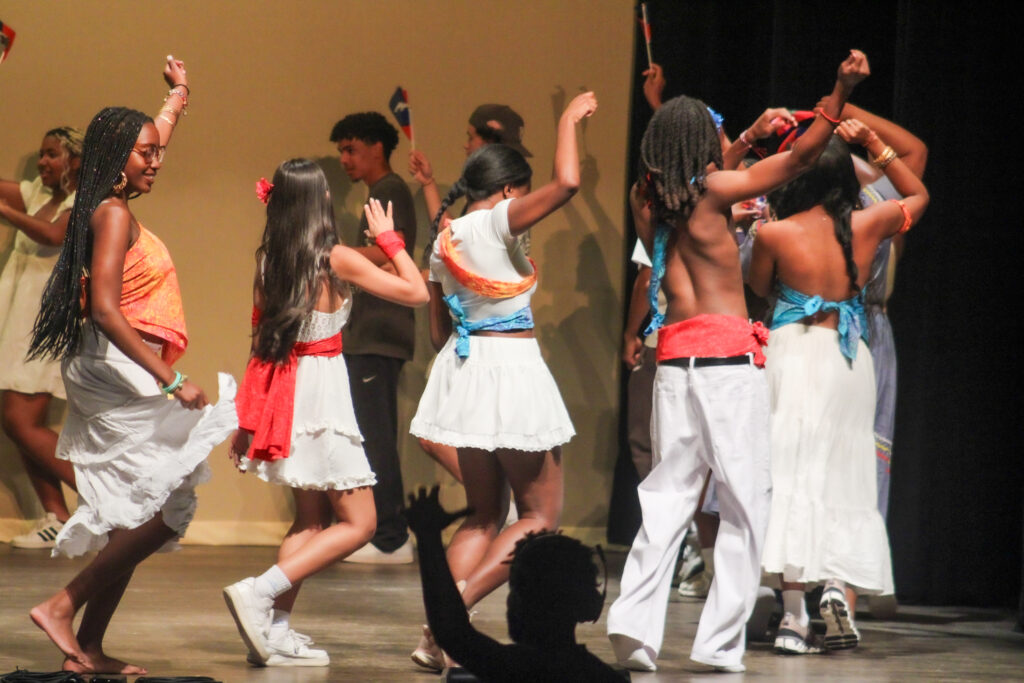 students dancing on stage at event