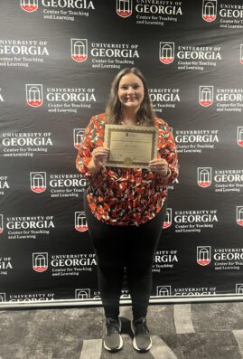 Lexie Little poses with a certificate.