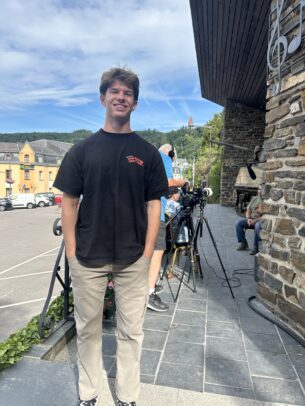 A young man poses for a photo.