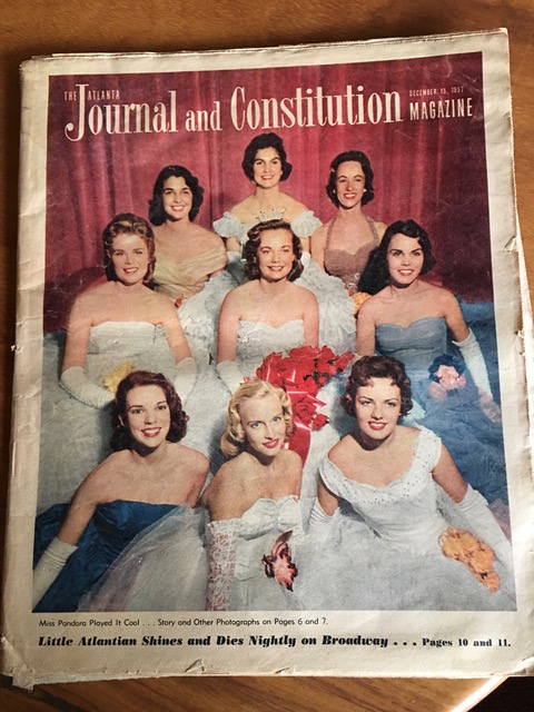 A Journal and Constitution magazine cover from 1957 showing 9 female college students sitting in debutante ball gowns.