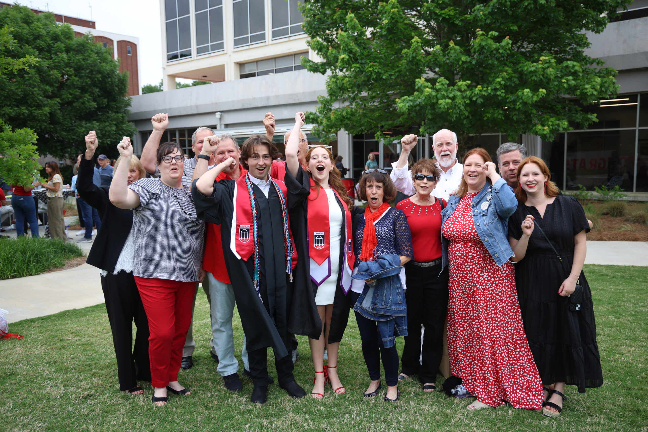 A group of people participating in a "Go Dawgs" chant on the Schnitzer Family Media Lawn.