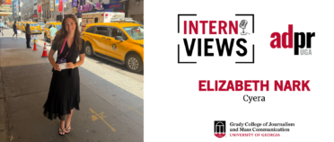 White InternViews graphic for Elizabeth Nark, an intern at Cyera accompanied by a picture of Elizabeth Nark standing outside in New York City holding her badge.