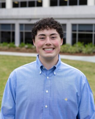 Headshot of Max Redmond in front of Grady College.