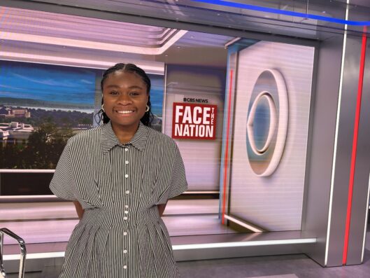 Courtney Craft smiles on the set of CBS Face the Nation.