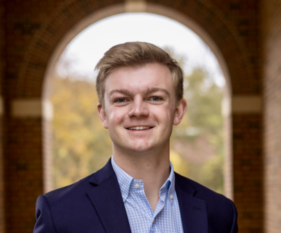 Headshot of Trent Polkinghorne standing in front of an arch.