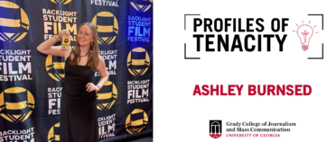 Woman standing in front of a backdrop