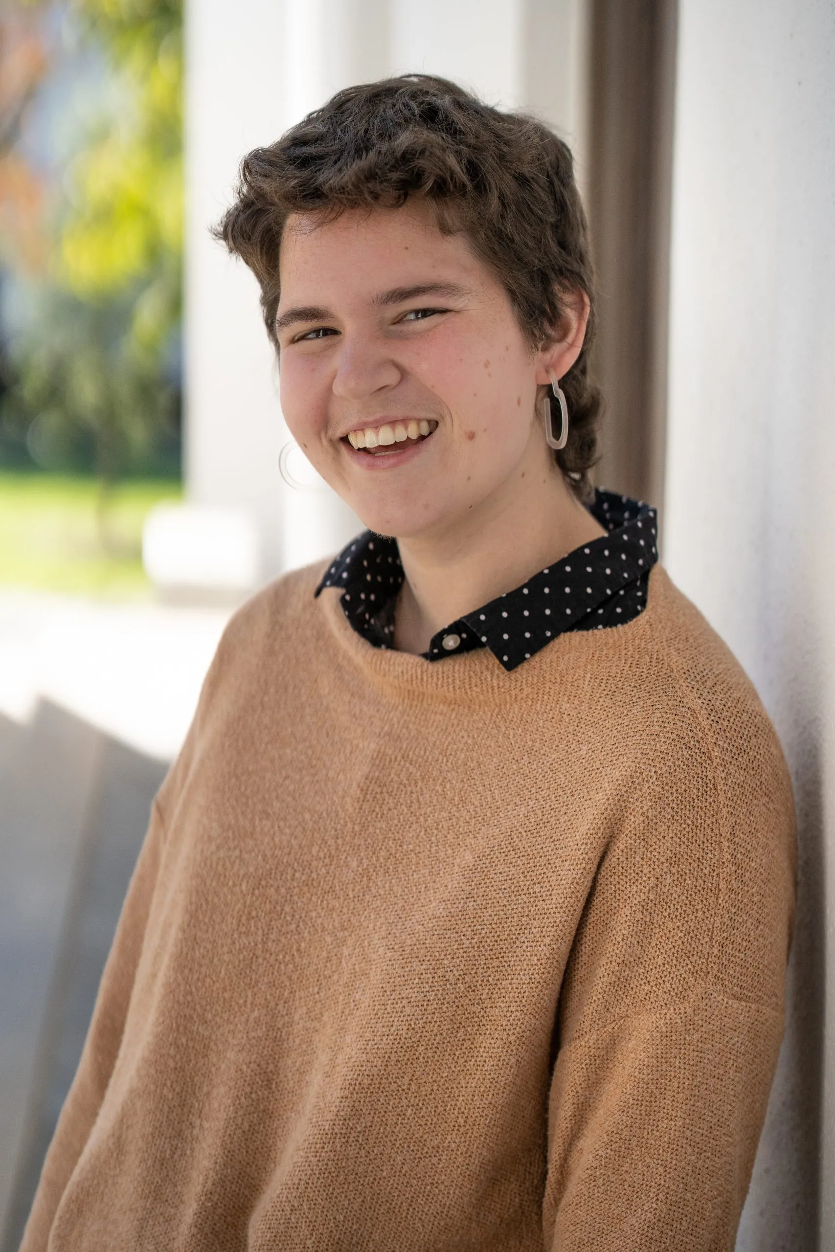 A profile for Lucy Grey Shields lists her as a fourth-year from Atlanta, GA. Her tenacity shines through her degrees, activities, and involvement, all displayed on a bold red background. The heading reads PROFILES OF TENACITY.
