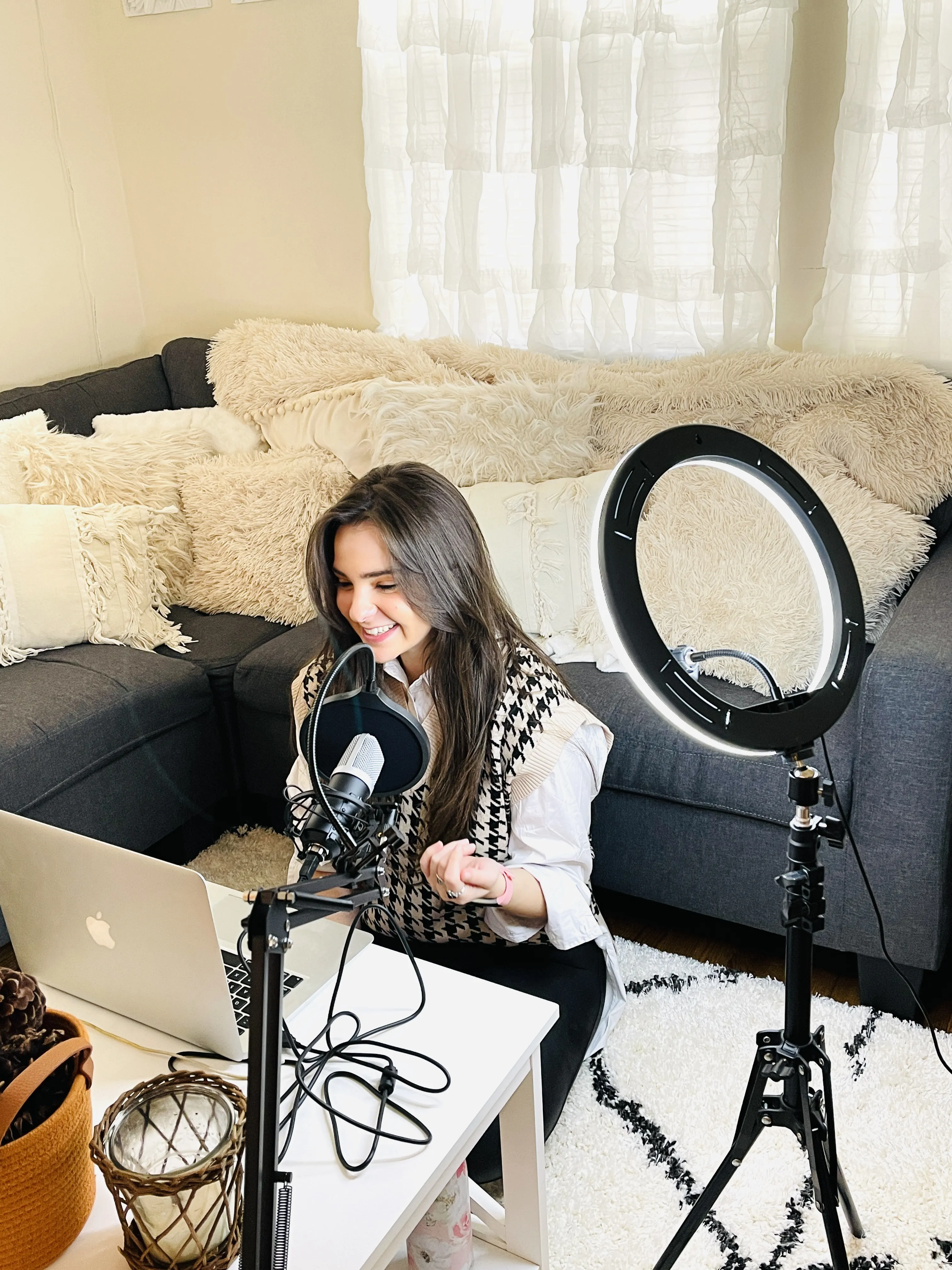 Noles talking into the microphone with a ring light shining on her while filming a podcast episode