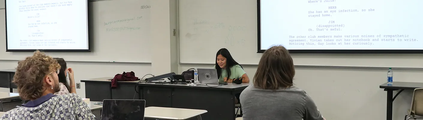 Students in the Writer's Room review a script on the screen. 