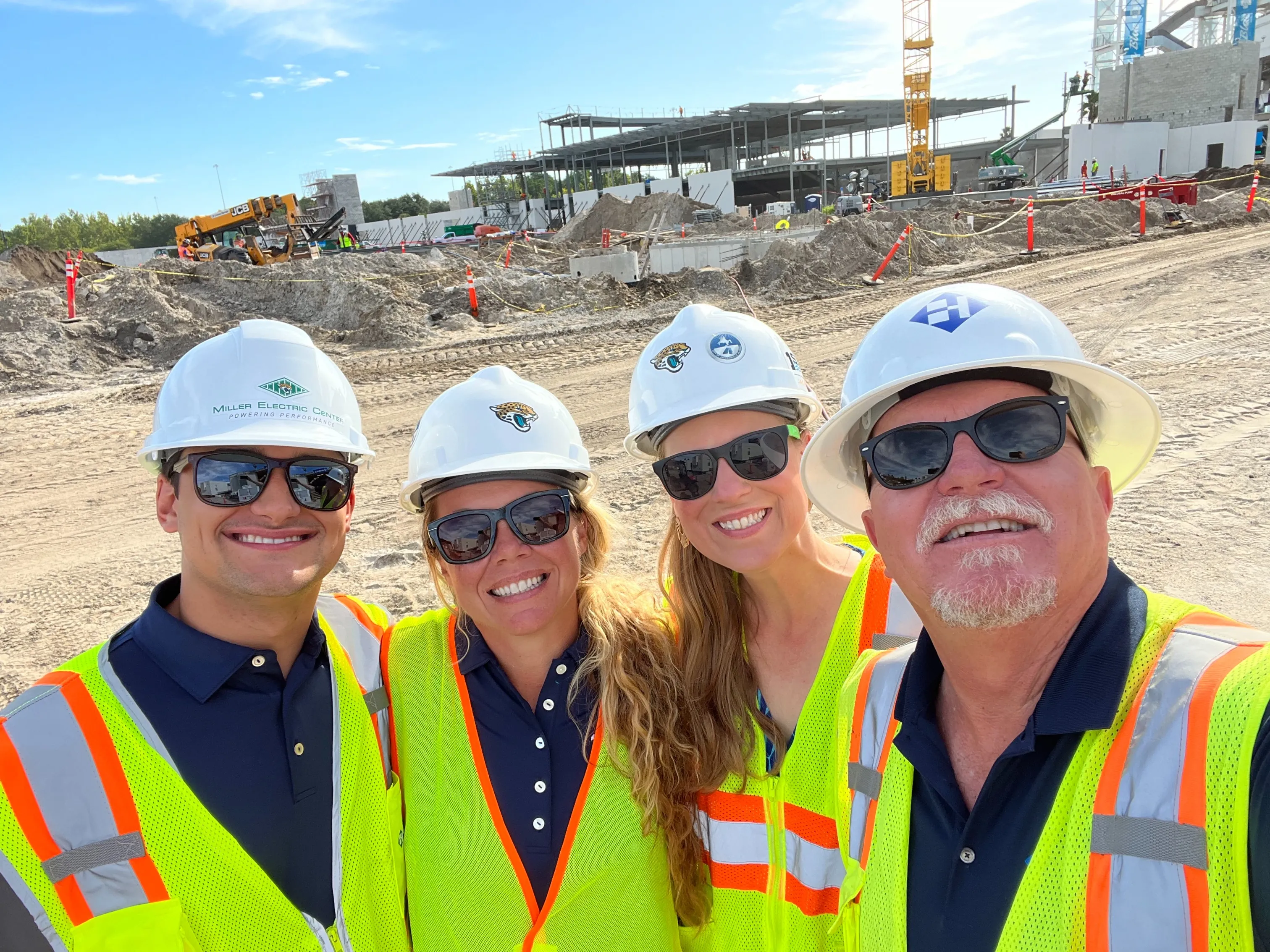 a picture of student Jonathan in a construction hat and vest with other workers