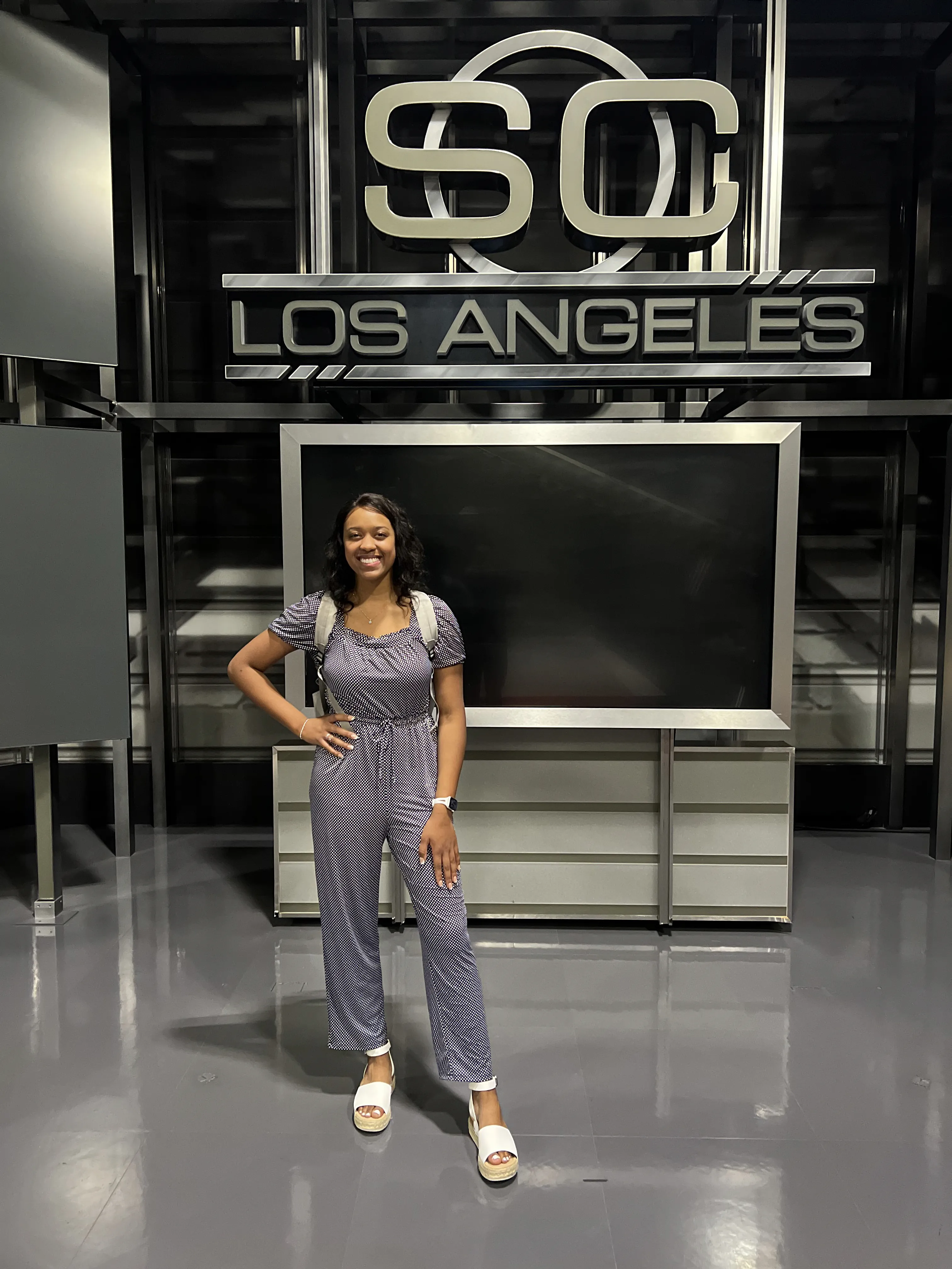 student standing in front of sportscenter logo