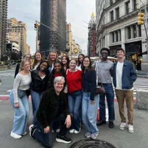 Students pose in front of the Flat Iron Building in New York City.