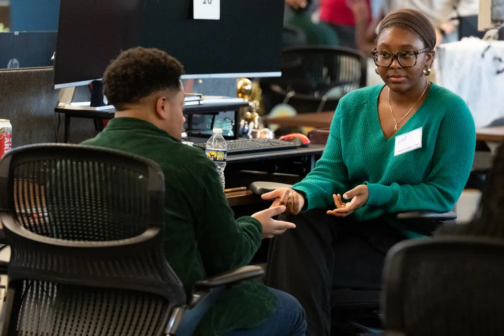 A student meets with a professional for a speed advice session.