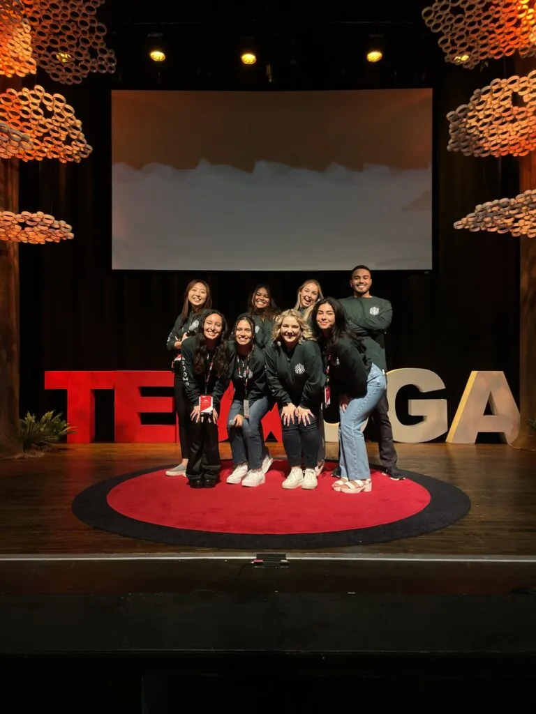 Valdes poses with students at TEDxUGA.