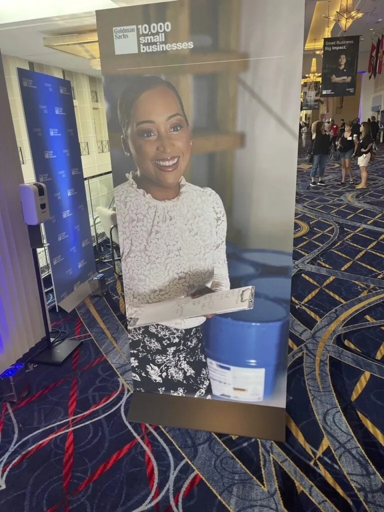 A photo of Marie Hunter on a large display in a conference center lobby.