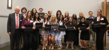 A group of students, the 2024 Levin Leaders, stand holding certificates.