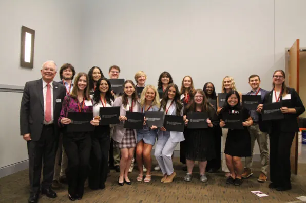 A group of students, the 2024 Levin Leaders, stand holding certificates.