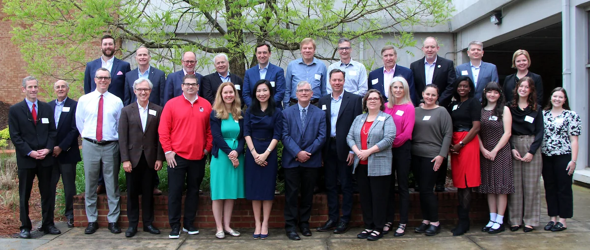 A group photo of the CCTT members standing outside Grady College.