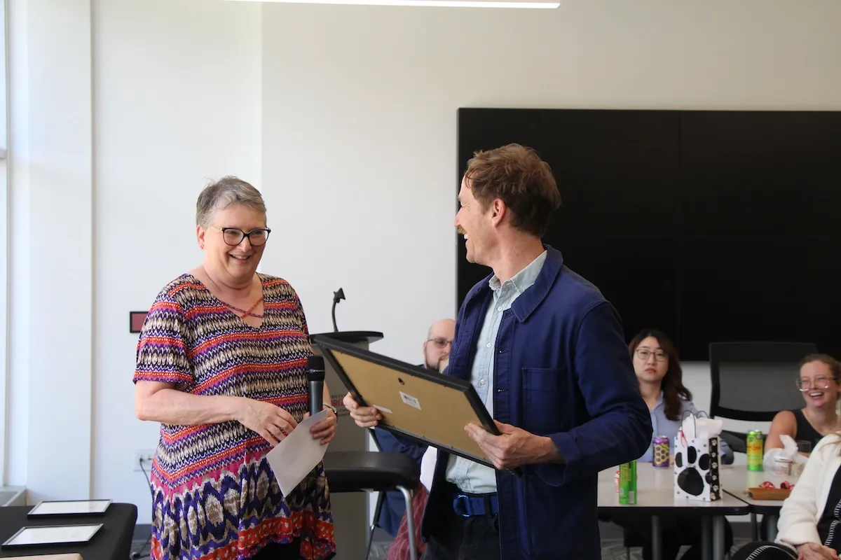 Keith Wilson accepts the Diversity and Inclusion Advocacy Award, presented by Janice Hume, associate dean for academic affairs.