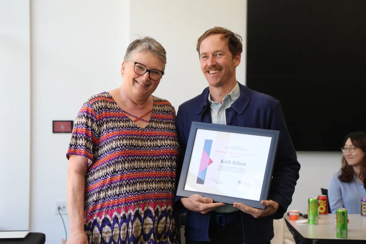 Keith Wilson accepts the Diversity and Inclusion Advocacy Award, presented by Janice Hume, associate dean for academic affairs.