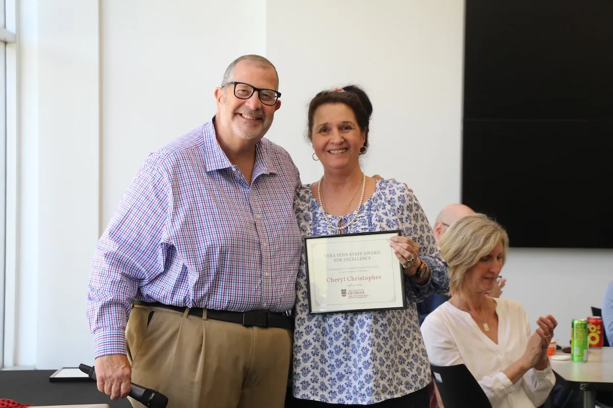 Cheryl Christopher accepts the Vera Penn Staff Award for Excellence, presented by Dean Charles Davis.
