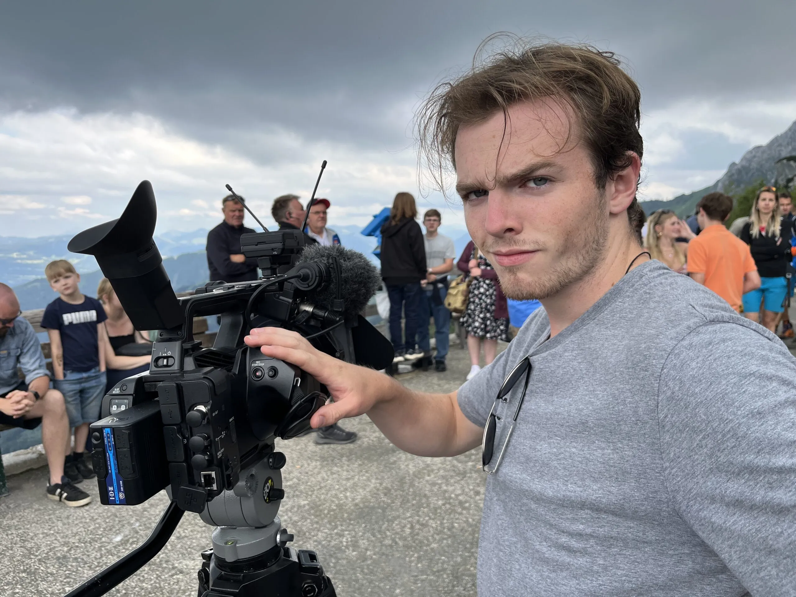 Student on the WWII foundation Filmmaking Program operating a video camera on set.