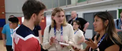 Students interview an athlete at the Paralympics.