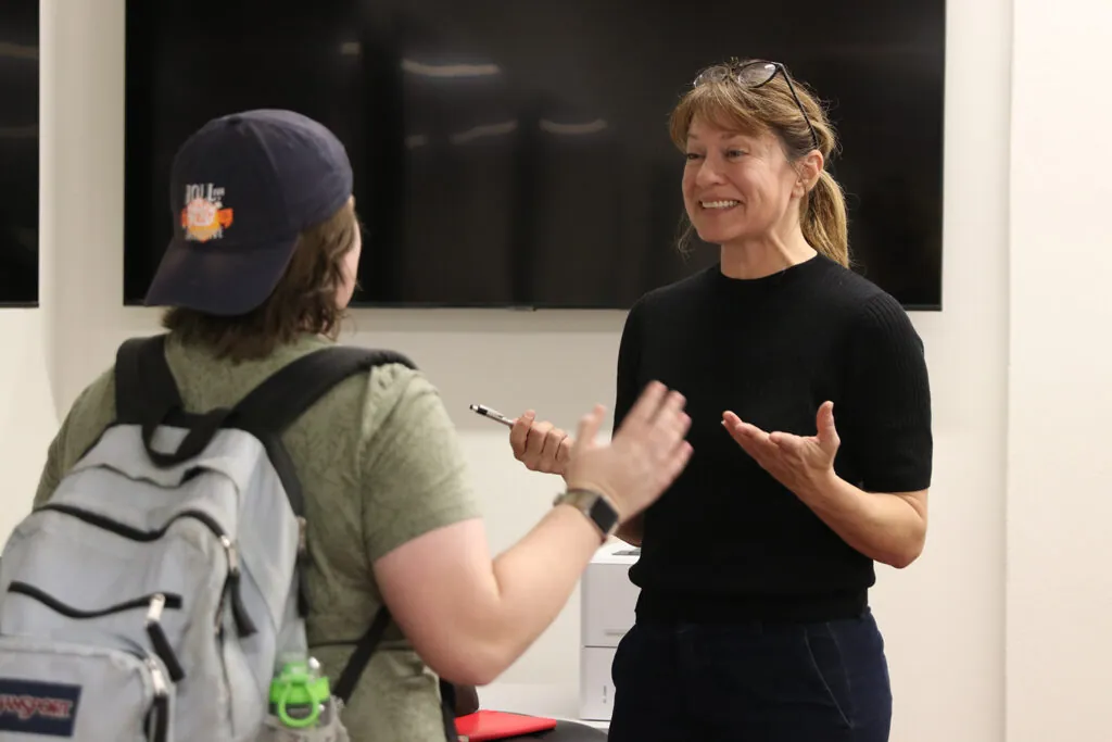 Andrea Bruce talks with a student.