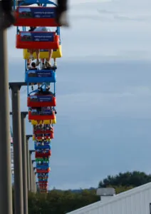 A line of tram cars travel overhead at the fair.