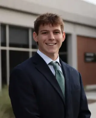 Headshot of Harrison Hastings in front of Grady Colllege