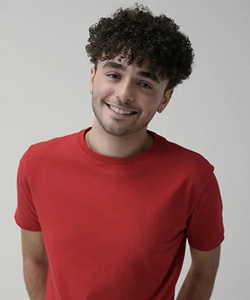 Photo of a young man in a red shirt posing for a headshot.