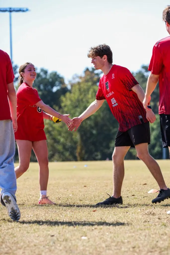 spikeball players interact at game