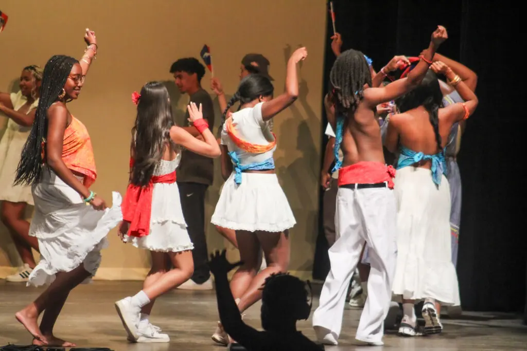 students dancing on stage at event