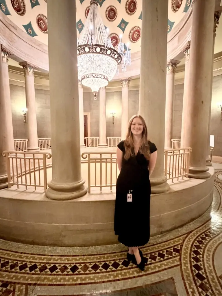 Aubrey Skinner smiles in a long black dress in the US Capitol building.