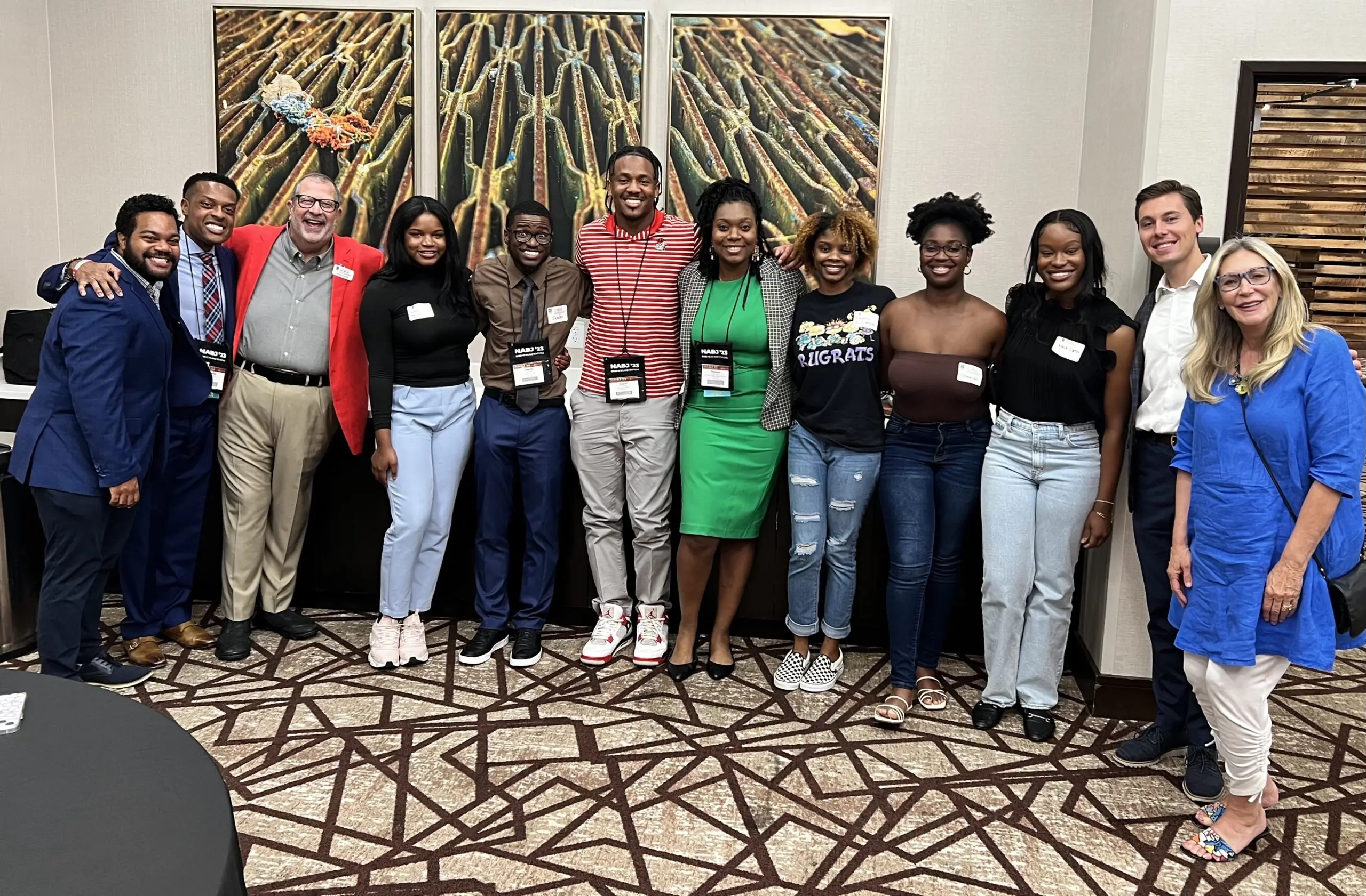 Dean Davis and NABJ members and alumni pose for a picture.