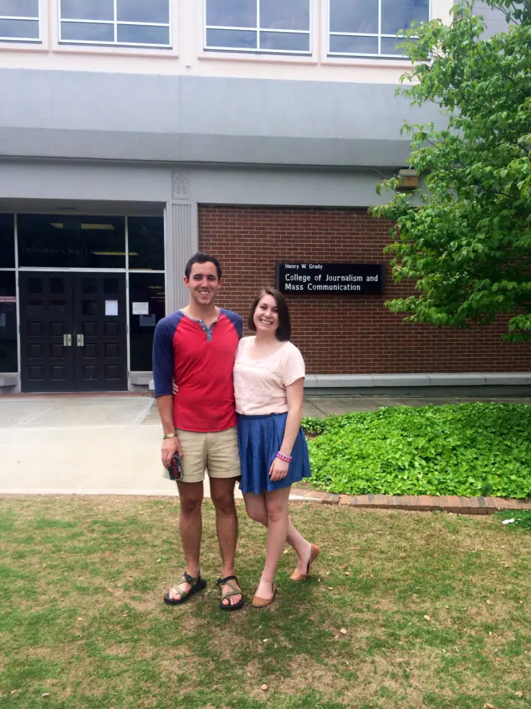 Patrick Klibanoff stands on the Schnitzer Family Media Lawn outside of Grady College alongside a female classmate.